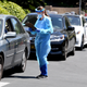 Workers perform drive-up covid-19 testing administered from a car at Mend Urgent Care testing site at the Westfield mall in Culver City, California on April 24, 2020.